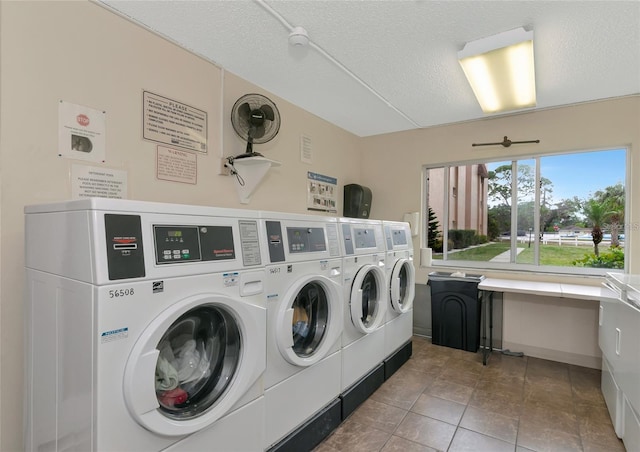 laundry room featuring tile patterned flooring, a textured ceiling, and independent washer and dryer