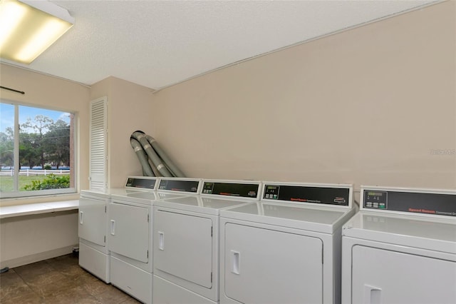 washroom with washer and dryer and a textured ceiling