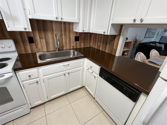 kitchen with white appliances, sink, light tile patterned floors, and white cabinets