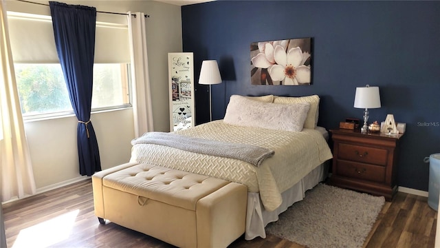 bedroom with dark hardwood / wood-style flooring