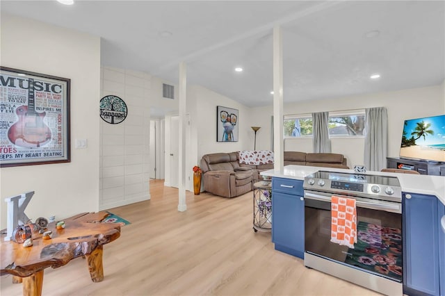 kitchen with stainless steel electric range, light hardwood / wood-style flooring, lofted ceiling, and blue cabinets