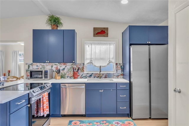 kitchen with stainless steel appliances, plenty of natural light, backsplash, and lofted ceiling