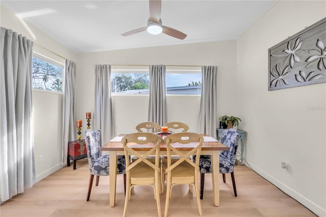 dining area featuring light hardwood / wood-style floors, ceiling fan, plenty of natural light, and vaulted ceiling