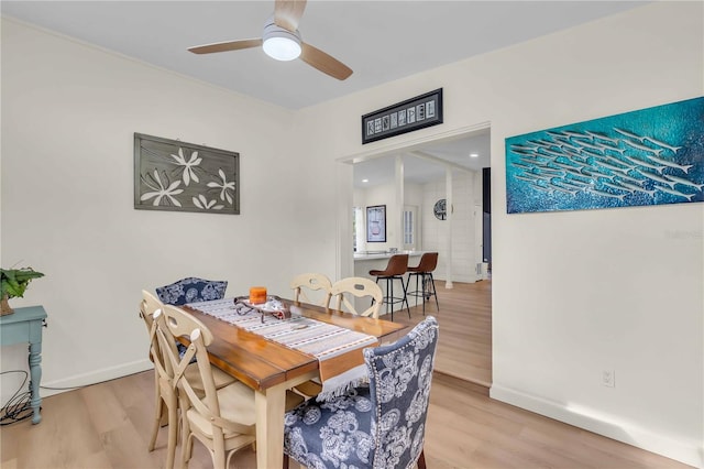 dining space featuring hardwood / wood-style floors and ceiling fan