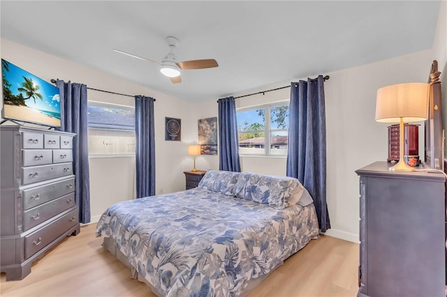 bedroom with light hardwood / wood-style floors and ceiling fan