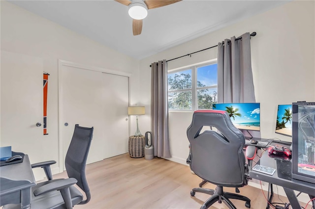 office space with ceiling fan, lofted ceiling, and light hardwood / wood-style floors