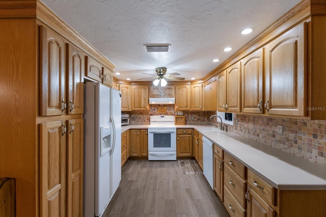 1640 Center Rd, Terra Ceia, FL 34250 - kitchen featuring white appliances, under cabinet range hood, dark wood-style floors, ceiling fan, and light countertops