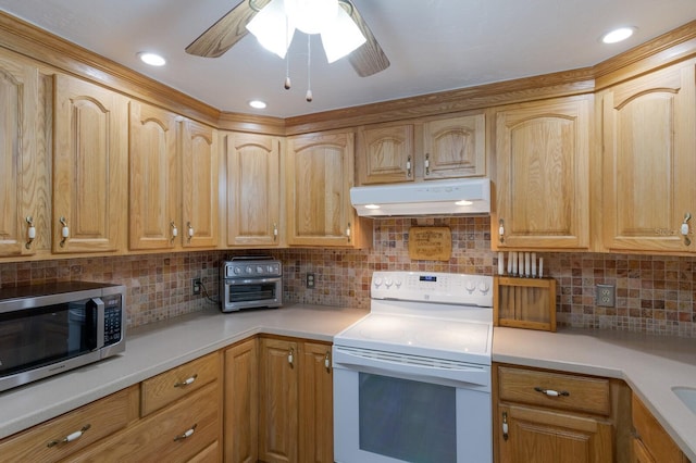 1640 Center Rd, Terra Ceia, FL 34250 - kitchen featuring white electric stove, stainless steel microwave, under cabinet range hood, light countertops, and a ceiling fan