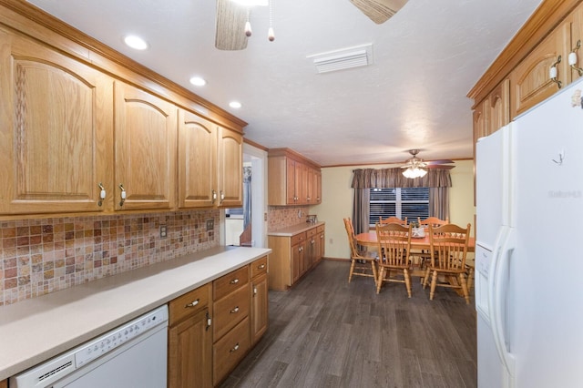 kitchen featuring decorative backsplash, dark hardwood / wood-style floors, white appliances, and ceiling fan