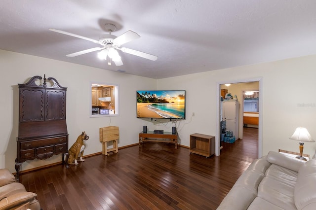 living room featuring visible vents, baseboards, ceiling fan, and wood finished floors