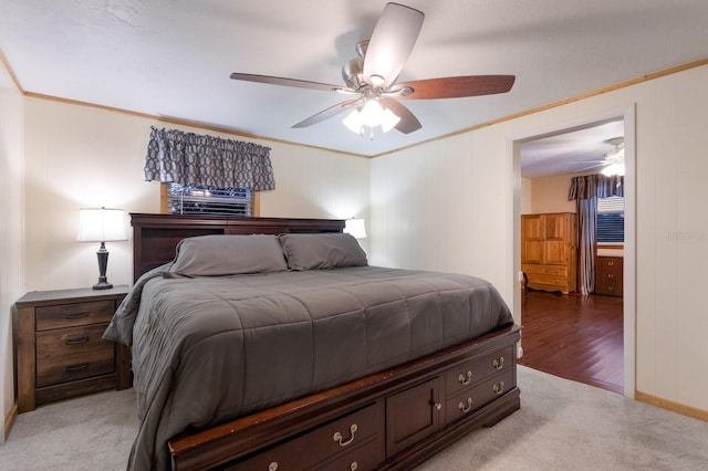 bedroom featuring light colored carpet, crown molding, and ceiling fan