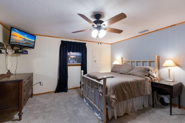 carpeted bedroom featuring ceiling fan and crown molding