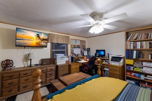 bedroom featuring a textured ceiling, wood walls, and ceiling fan