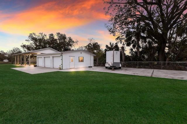 1640 Center Rd, Terra Ceia, FL 34250 - back of house featuring an outdoor structure, a garage, concrete driveway, and a patio