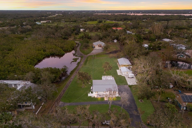 aerial view at dusk with a water view