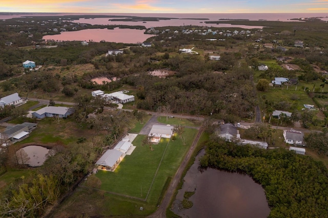 aerial view at dusk with a water view