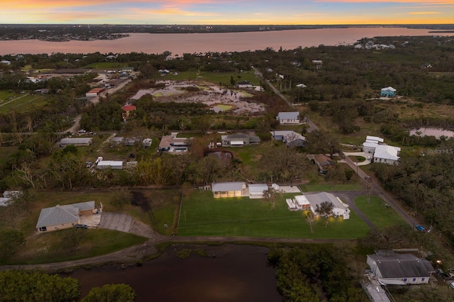 aerial view at dusk with a water view