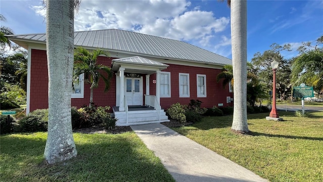 1640 Center Rd, Terra Ceia, FL 34250 - view of front facade featuring a front yard, metal roof, and a standing seam roof