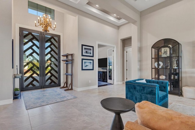 tiled foyer with a chandelier and a high ceiling