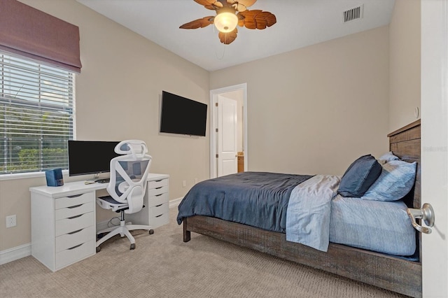 bedroom featuring light colored carpet and ceiling fan