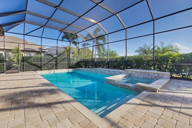 view of pool with a patio, a lanai, and an in ground hot tub