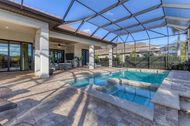 view of swimming pool featuring a patio, ceiling fan, glass enclosure, and an in ground hot tub