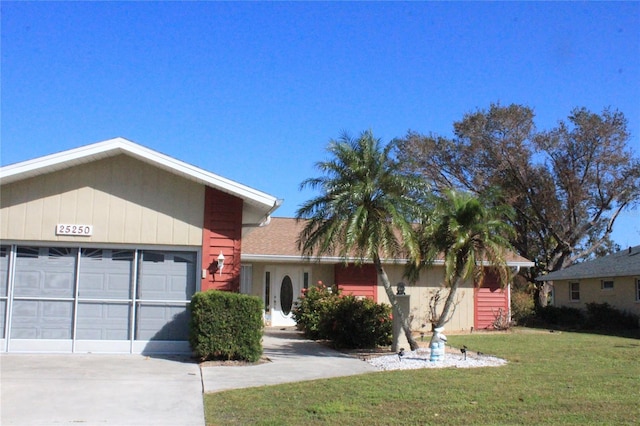 single story home with a garage and a front lawn