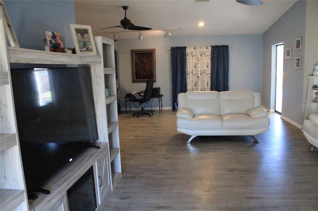 living room with hardwood / wood-style floors, ceiling fan, and vaulted ceiling