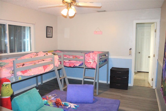 bedroom with hardwood / wood-style flooring and ceiling fan