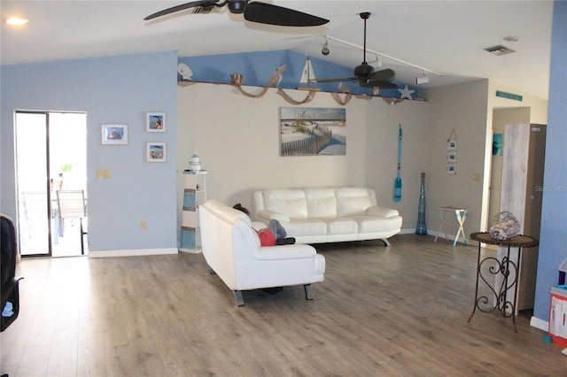 living room with lofted ceiling, dark hardwood / wood-style floors, and ceiling fan