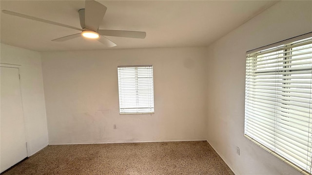 spare room with carpet floors and ceiling fan