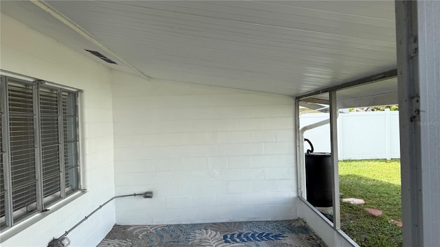 unfurnished sunroom featuring lofted ceiling