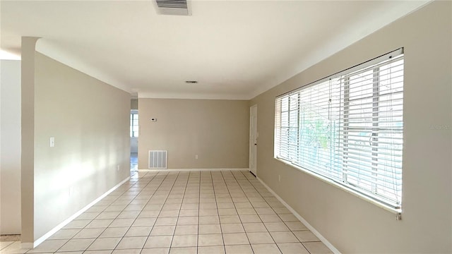 spare room with plenty of natural light and light tile patterned floors