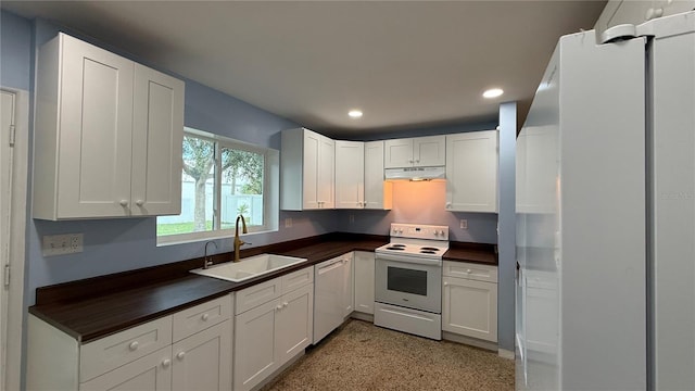 kitchen featuring white cabinets, white appliances, and sink