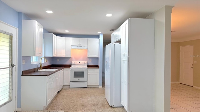 kitchen featuring white appliances, white cabinetry, sink, and light carpet