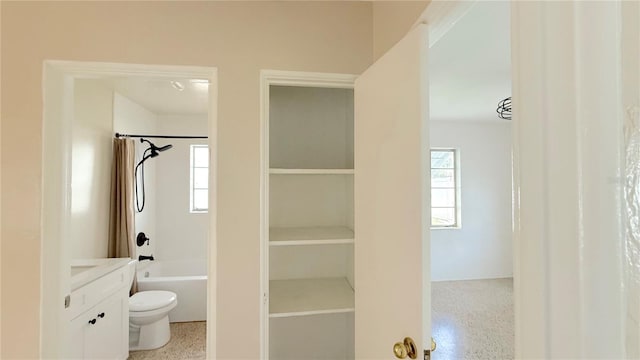 full bathroom featuring toilet, vanity, and shower / bathtub combination with curtain