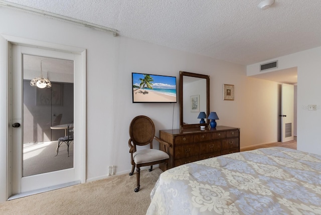 bedroom with a textured ceiling and light carpet