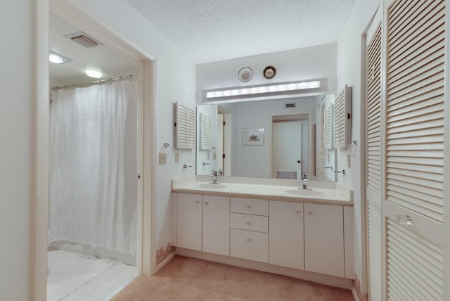 bathroom with vanity and a textured ceiling