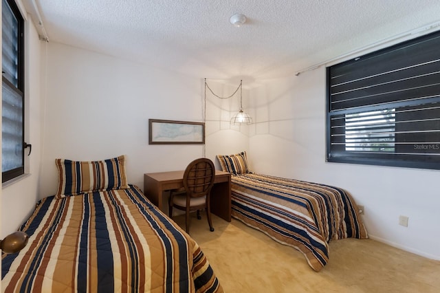 bedroom featuring a textured ceiling and carpet floors