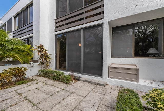 property entrance featuring a patio area