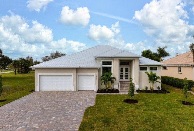 view of front of home with a garage and a front lawn