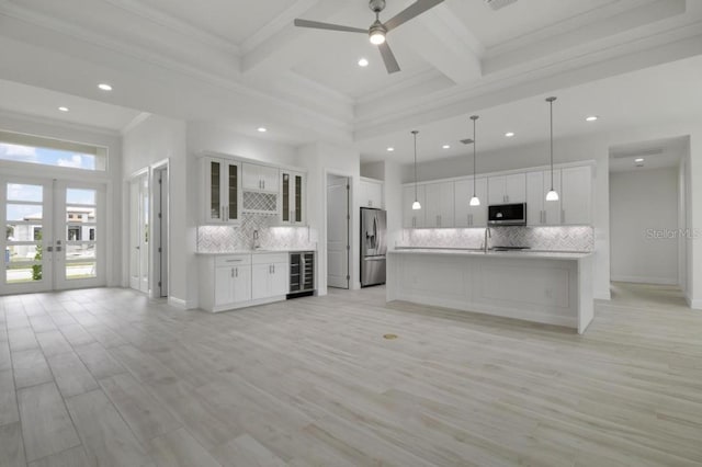 kitchen featuring white cabinets, light hardwood / wood-style flooring, and appliances with stainless steel finishes