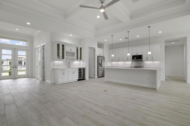 16381 Cape Horn Blvd, Punta Gorda, FL 33955 - unfurnished living room featuring wine cooler, recessed lighting, ornamental molding, a ceiling fan, and french doors