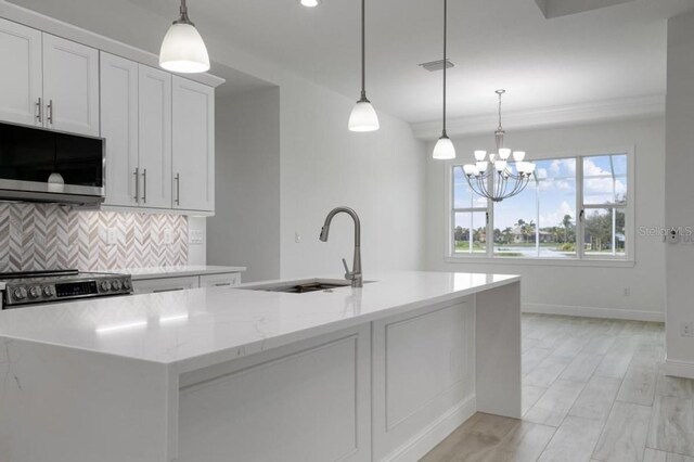 16381 Cape Horn Blvd, Punta Gorda, FL 33955 - kitchen with appliances with stainless steel finishes, a sink, decorative backsplash, light stone counters, and baseboards