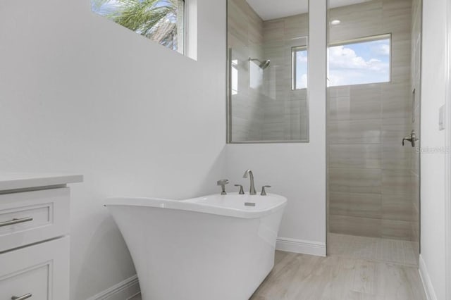 bathroom with shower with separate bathtub and hardwood / wood-style flooring