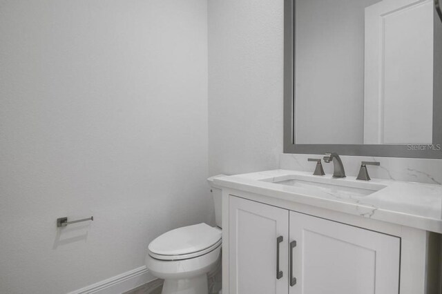 16381 Cape Horn Blvd, Punta Gorda, FL 33955 - bathroom with vanity, toilet, and baseboards