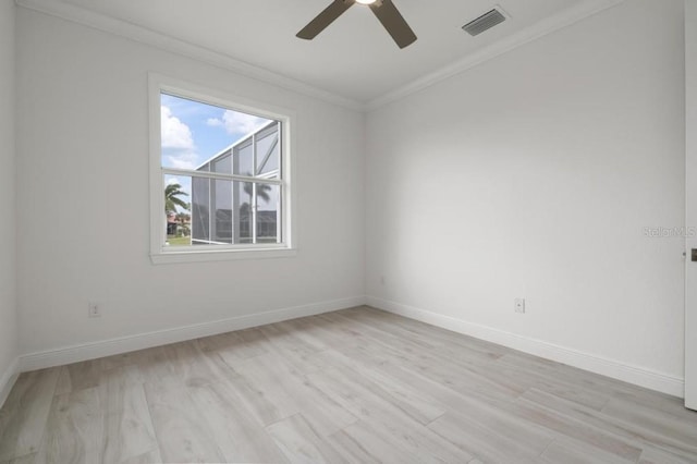 spare room featuring light hardwood / wood-style floors, ceiling fan, and crown molding