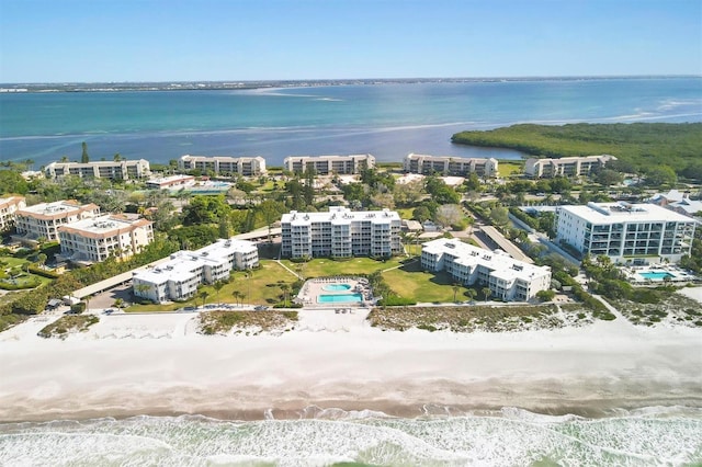 drone / aerial view with a beach view and a water view