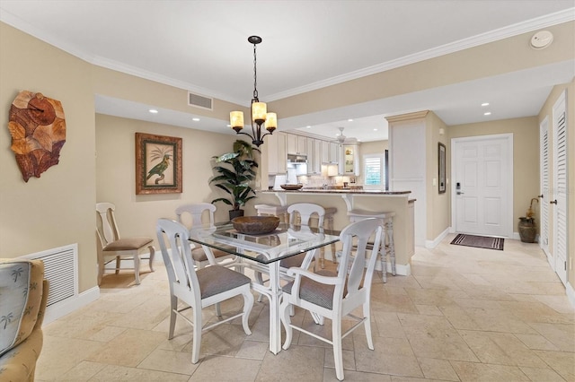 dining area with ornamental molding and a notable chandelier