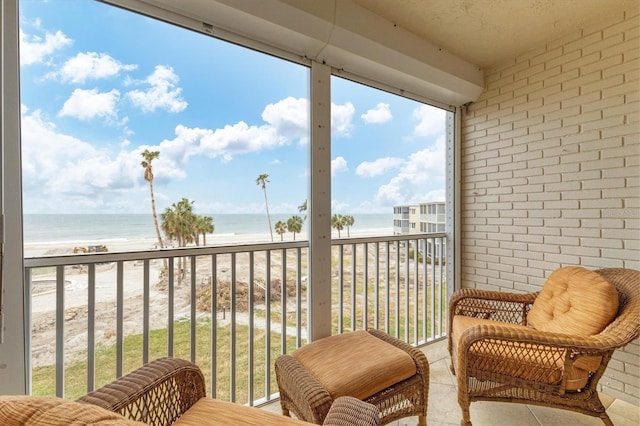 balcony with a beach view and a water view